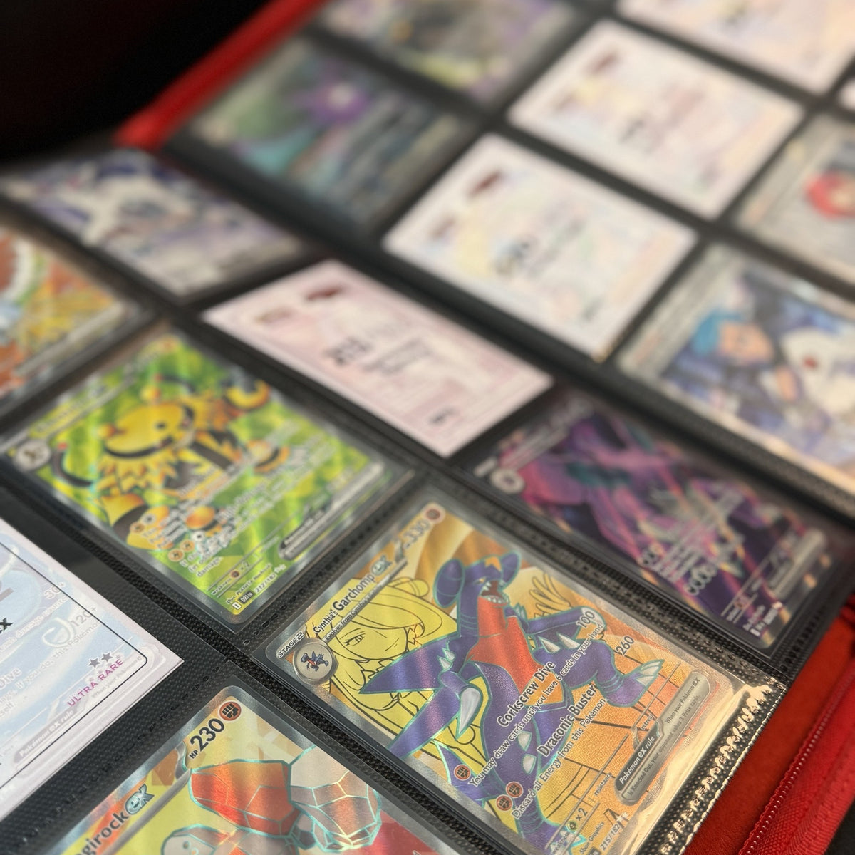 Destined Rivals placeholders holding gaps beside chase cards in a binder, Portal TCG